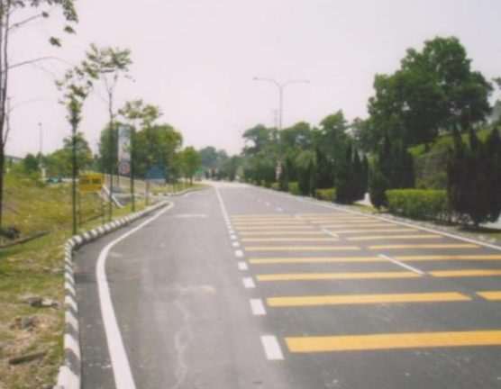 Paver laying premix asphalt on a new road in Negeri Sembilan